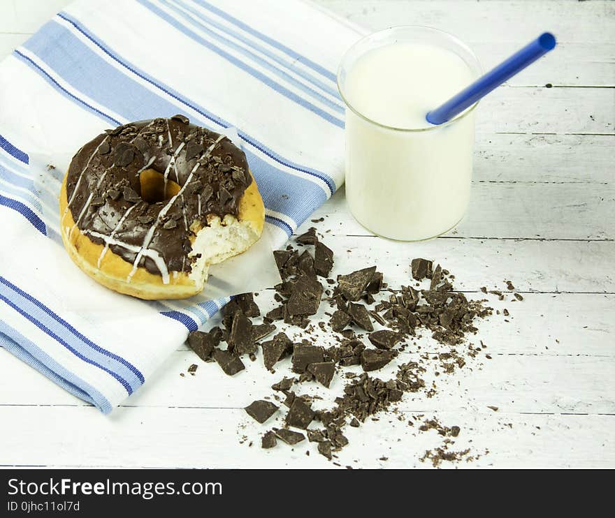 Chocolate Donut Beside Chunked Chocolates