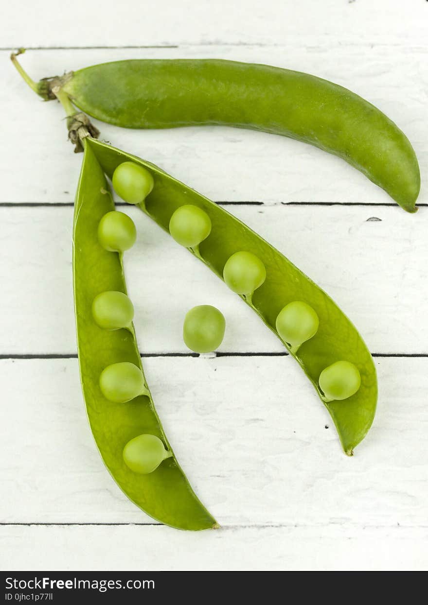 Green Peas Plant On White Surface