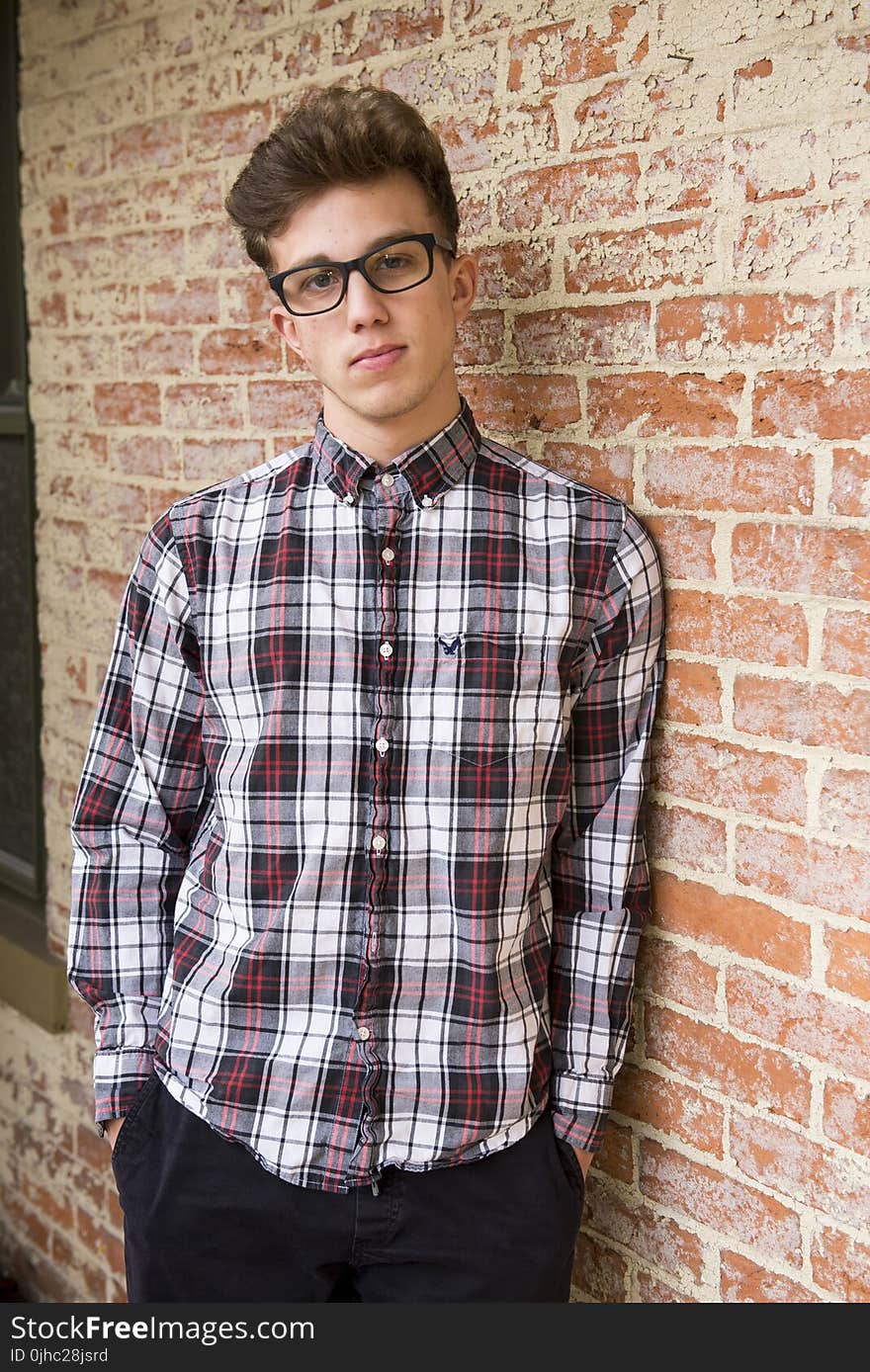 Man In Plaid Dress Shirt And Black Pants Wearing Eyeglasses