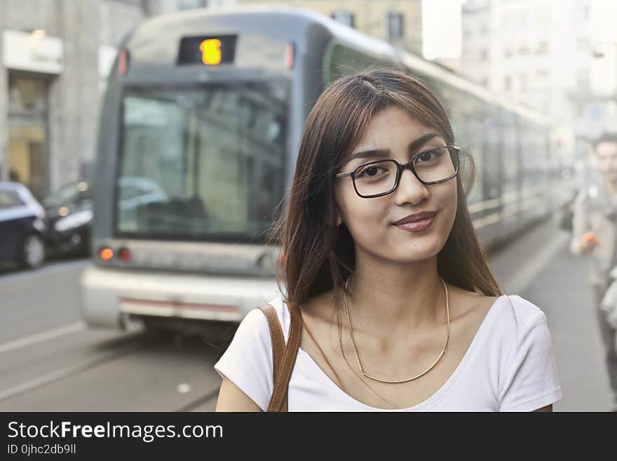 Woman in White Shirt With Eyeglasses Standing Near Train