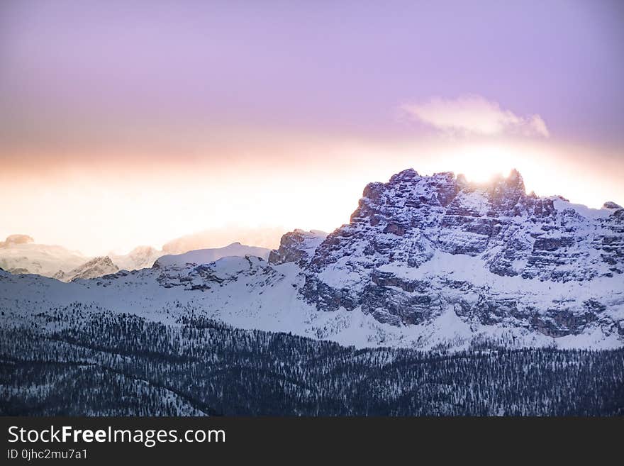 Mountain Cover by Snow Under Orange Sky