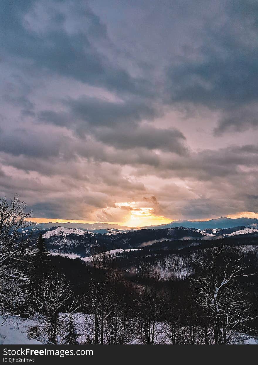 Photograph Of Snow Covered Mountains During Sunrise