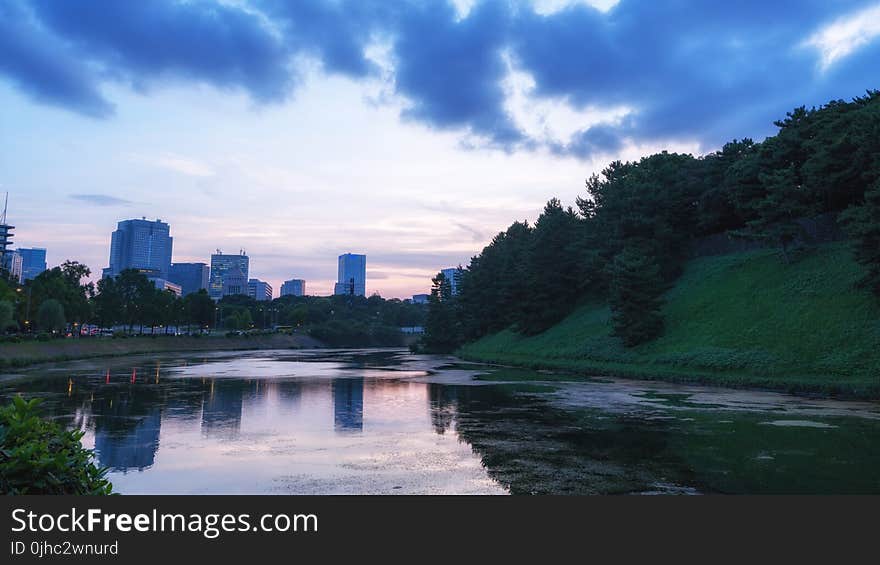 Landscape Photography of Body of Water and Green Hills