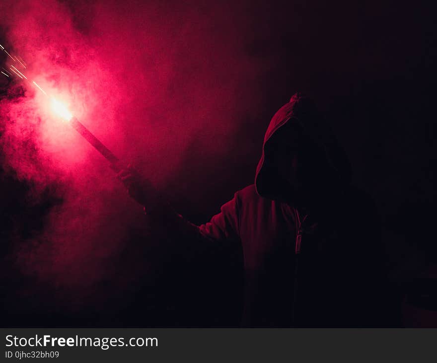 Hooded Figure Holding Red Flare