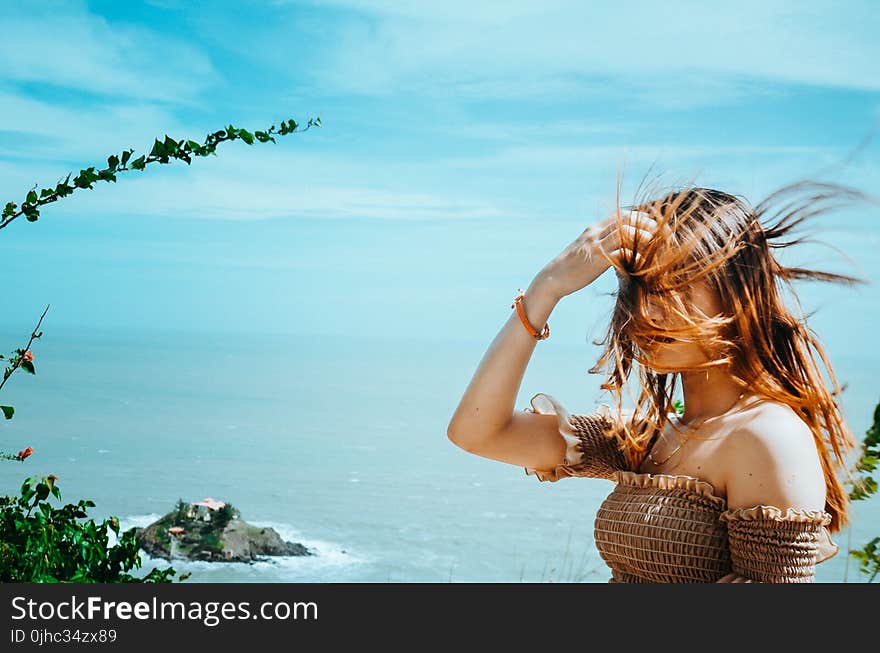 Photo of Woman in Brown Off-shoulder Top