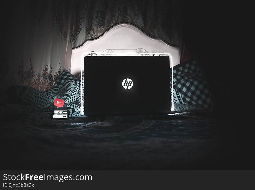 Black Hp Laptop on Bed Is on