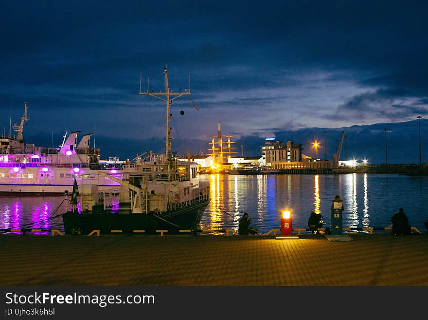 White Boat Near Dock during Nighttime