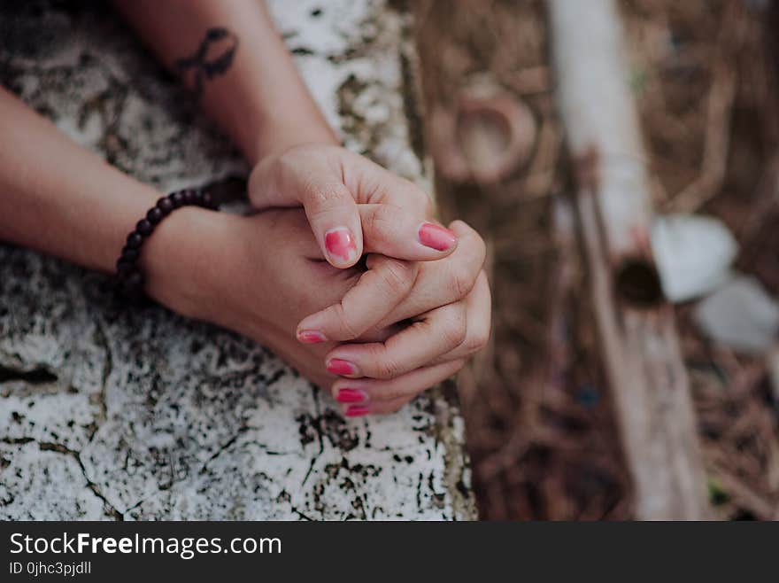 Depth of Field Photography of Human Hands on White Surface