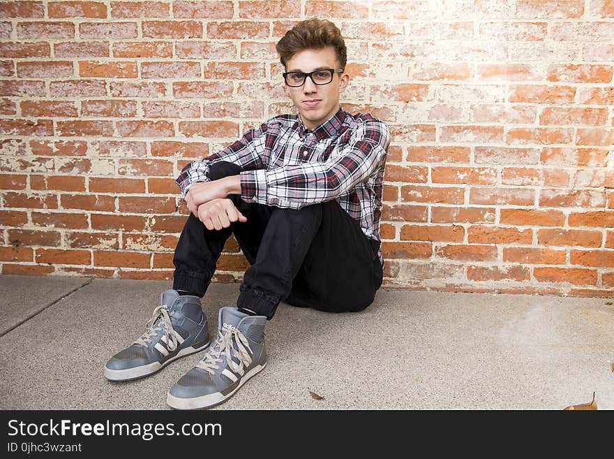 Man In Plaid Dress Shirt Sitting