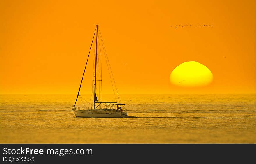 White Boat In The Middle Of The Sea During Sunset