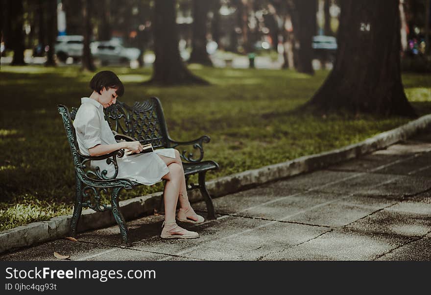 Woman Wearing White Dress Sitting on Bench