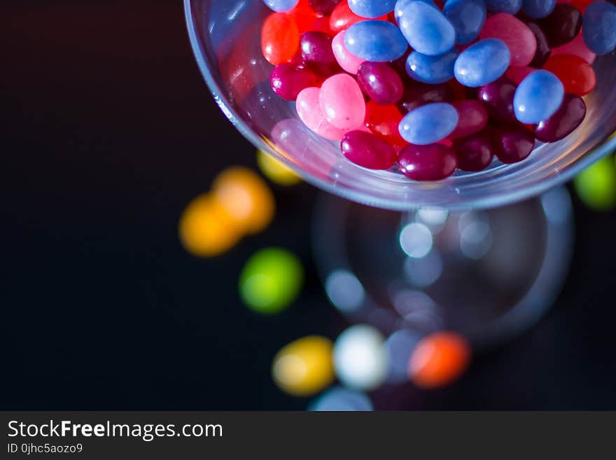 Selective Focus Photography of Jelly Beans on Jar