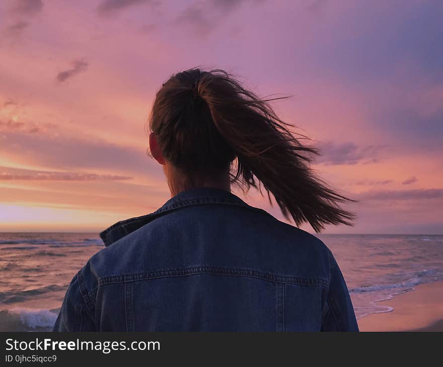 Woman Wearing Blue Denim Jacket Looking At The Beach