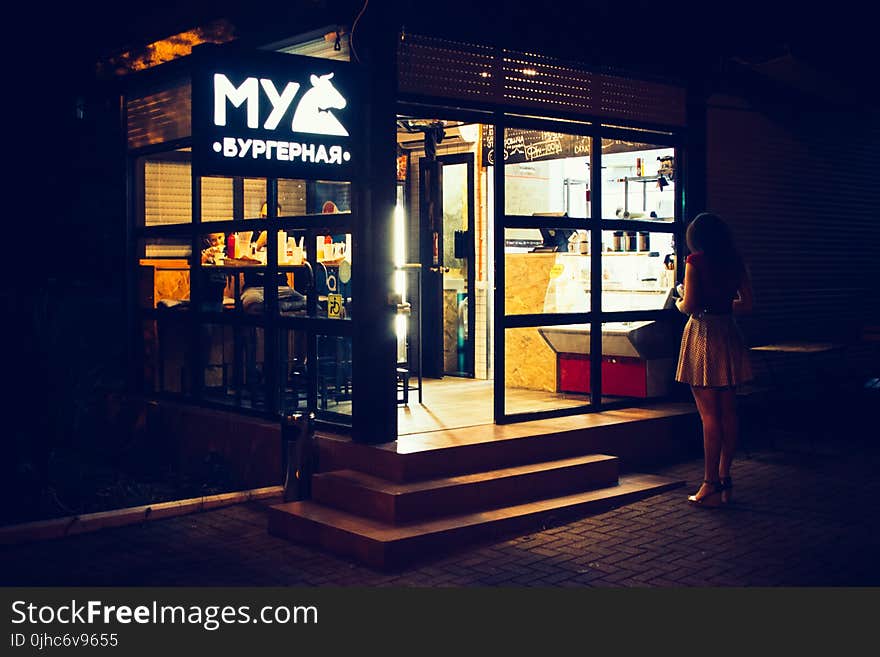 Photography of Woman Standing Near Restaurant