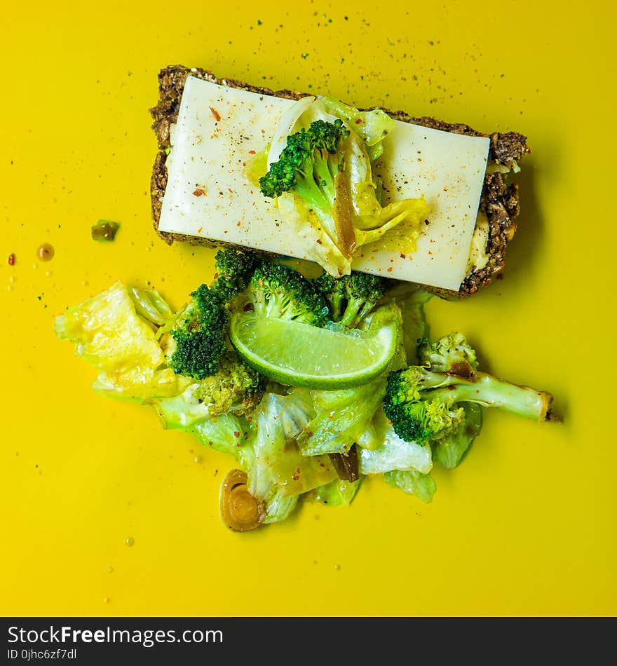 Photo of Green Broccoli, White Cheese and Green Cabbage on Yellow Surface