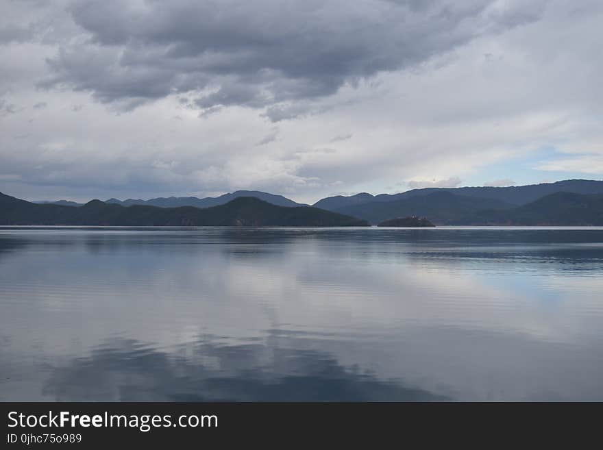 Photography of Mountains Near Body of Water