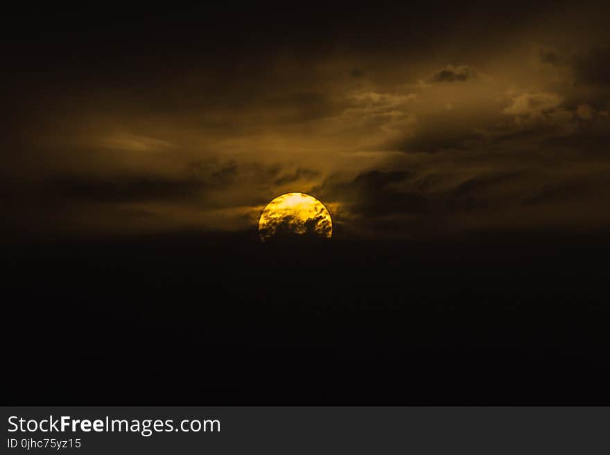 Photography of Moon Behind Clouds