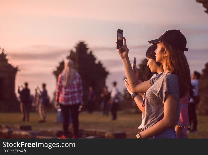 Woman Wearing Grey T-shirt Taking A Photo