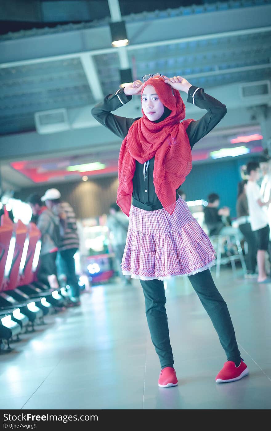 Woman in Red Head Scarf With Black Dress Shirt and Pink Skirt