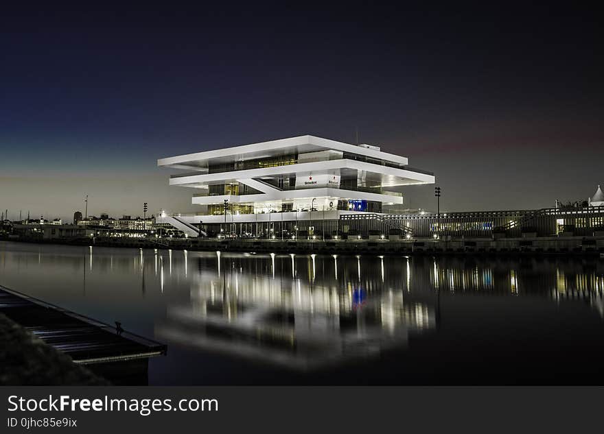 Photography of Multi-storey Building Near Body of Water