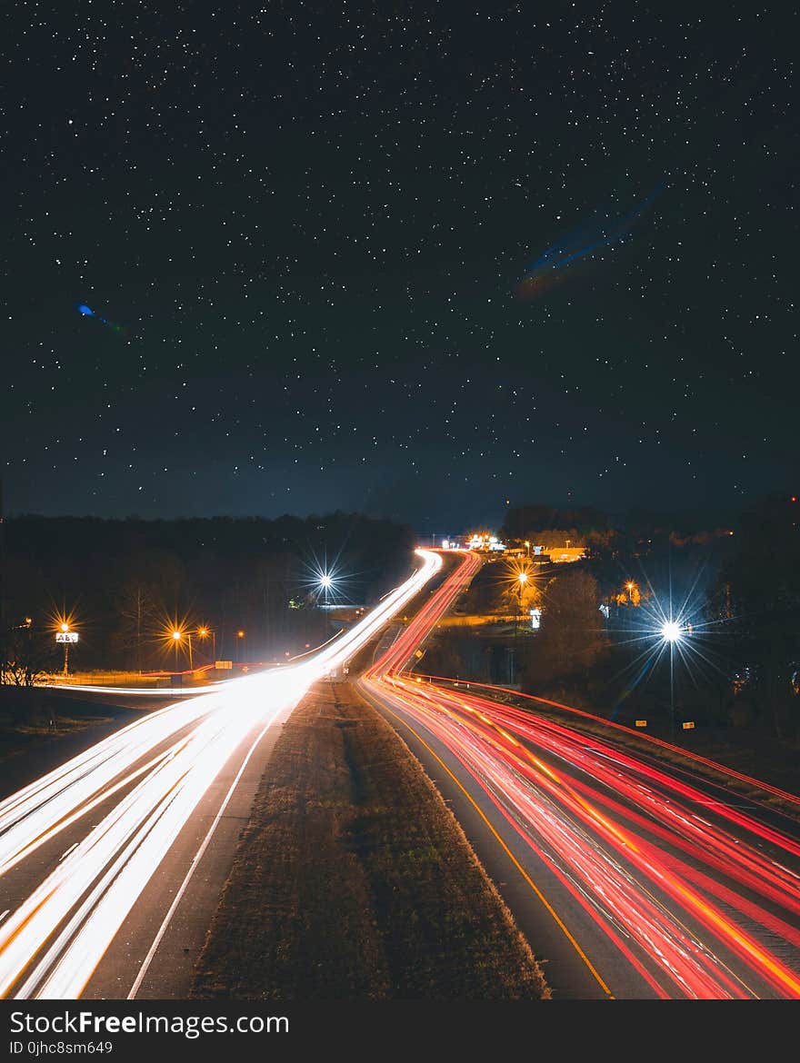 Timelapse Photography of Car Passing by the Road during Nighttime