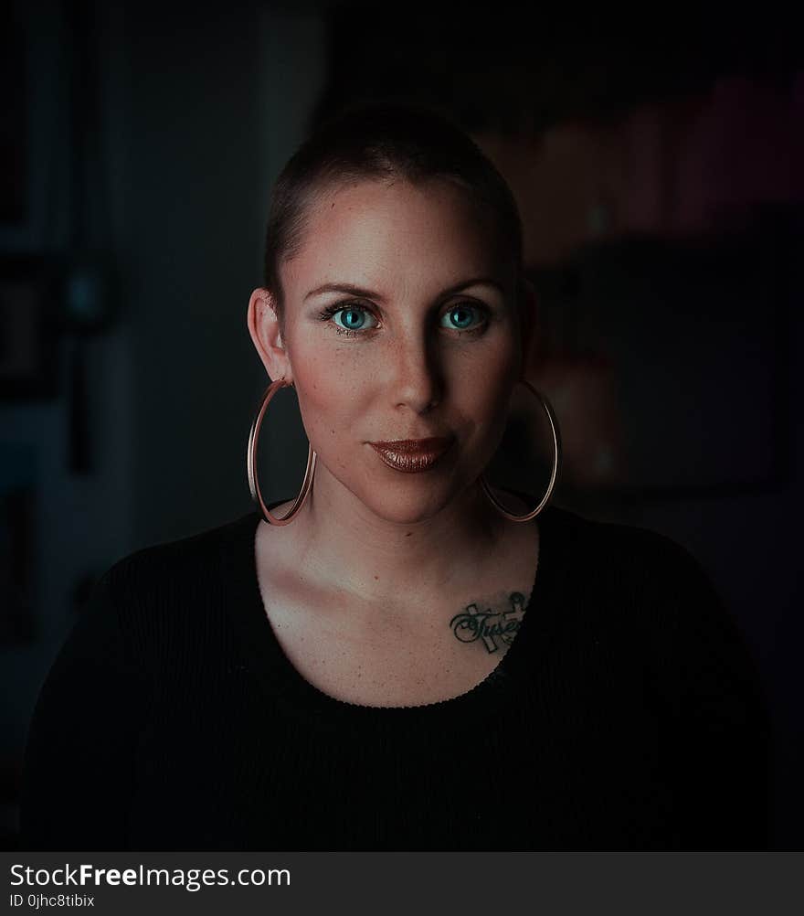 Woman Wearing Earrings and Black Shirt