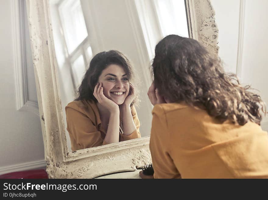 Photo of Woman Looking at the Mirror