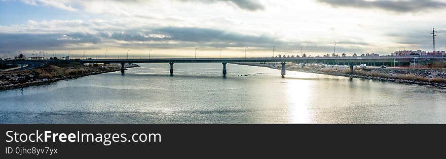 Panoramic Photography of Bridge Under Cloudy Sky