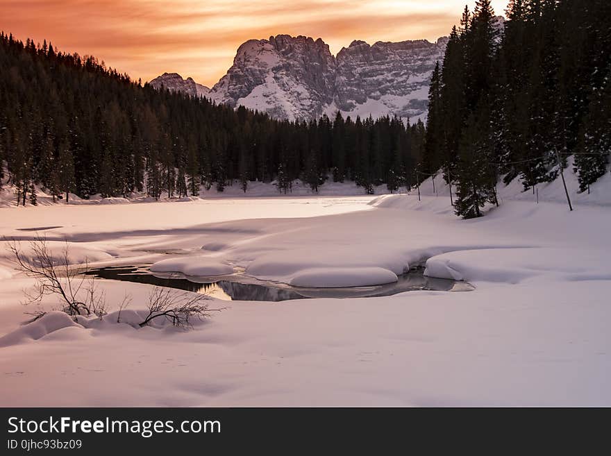 Landscape Photography Of Body Of Water Covered With Snow And Surrounded With Trees And Mountain