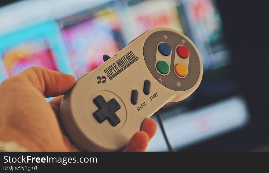 Person Holding White Snes Controller