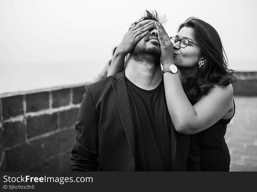 Grayscale Photography of Woman Covering Eyes of Man