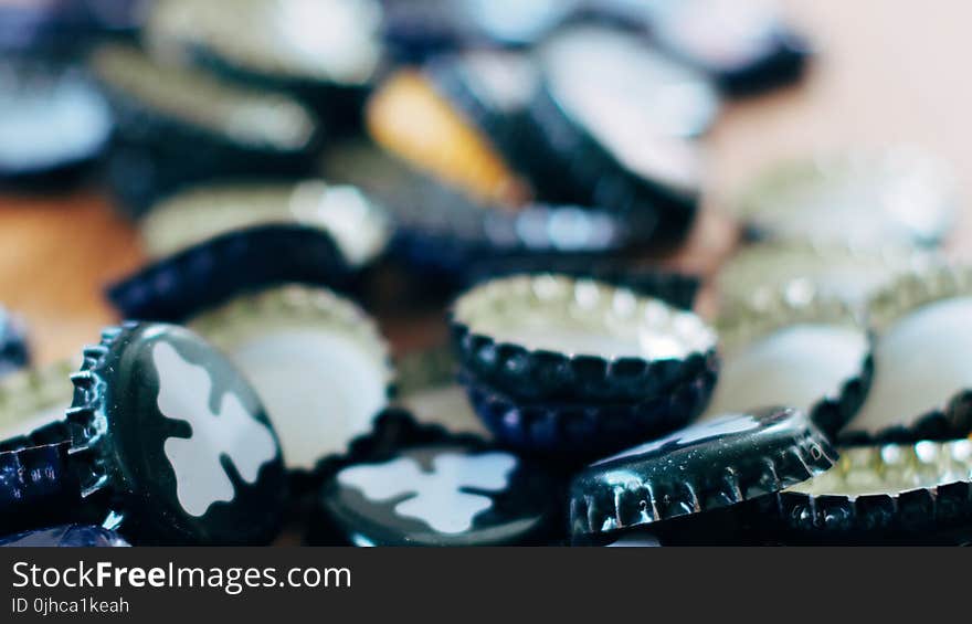 Close-up Photography of Black Bottle Cap Lot