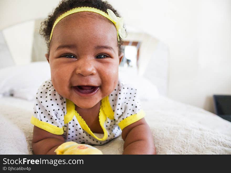 Baby Wearing White And Yellow Shirt