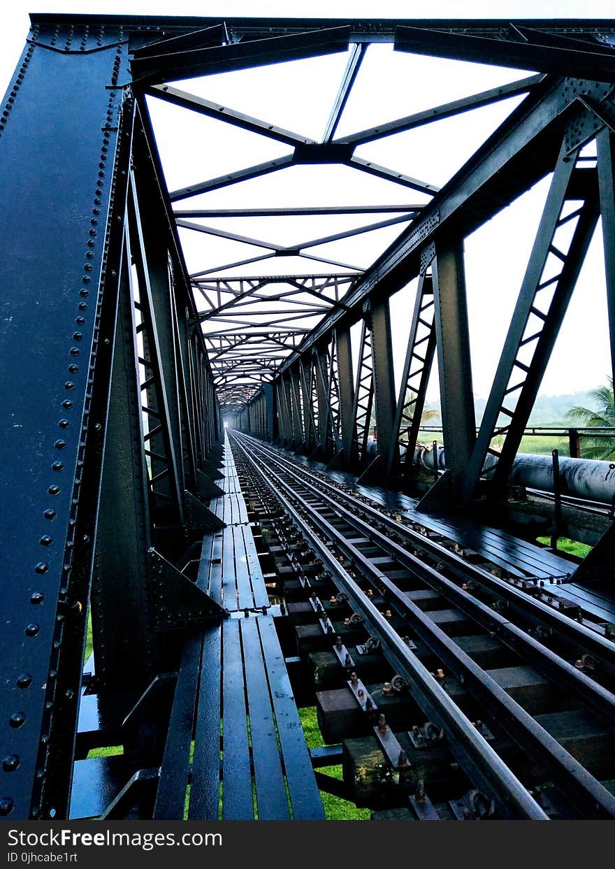 Train Track Bridge during Cloudy Skies