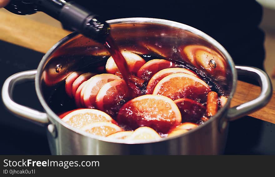 Silver Stock Pot With Liquid Substance and Lemon