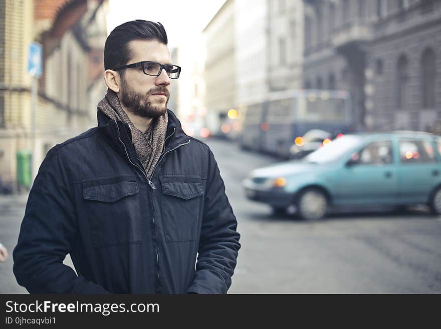 Man Wearing Black Zip-up Jacket Standing on the Street