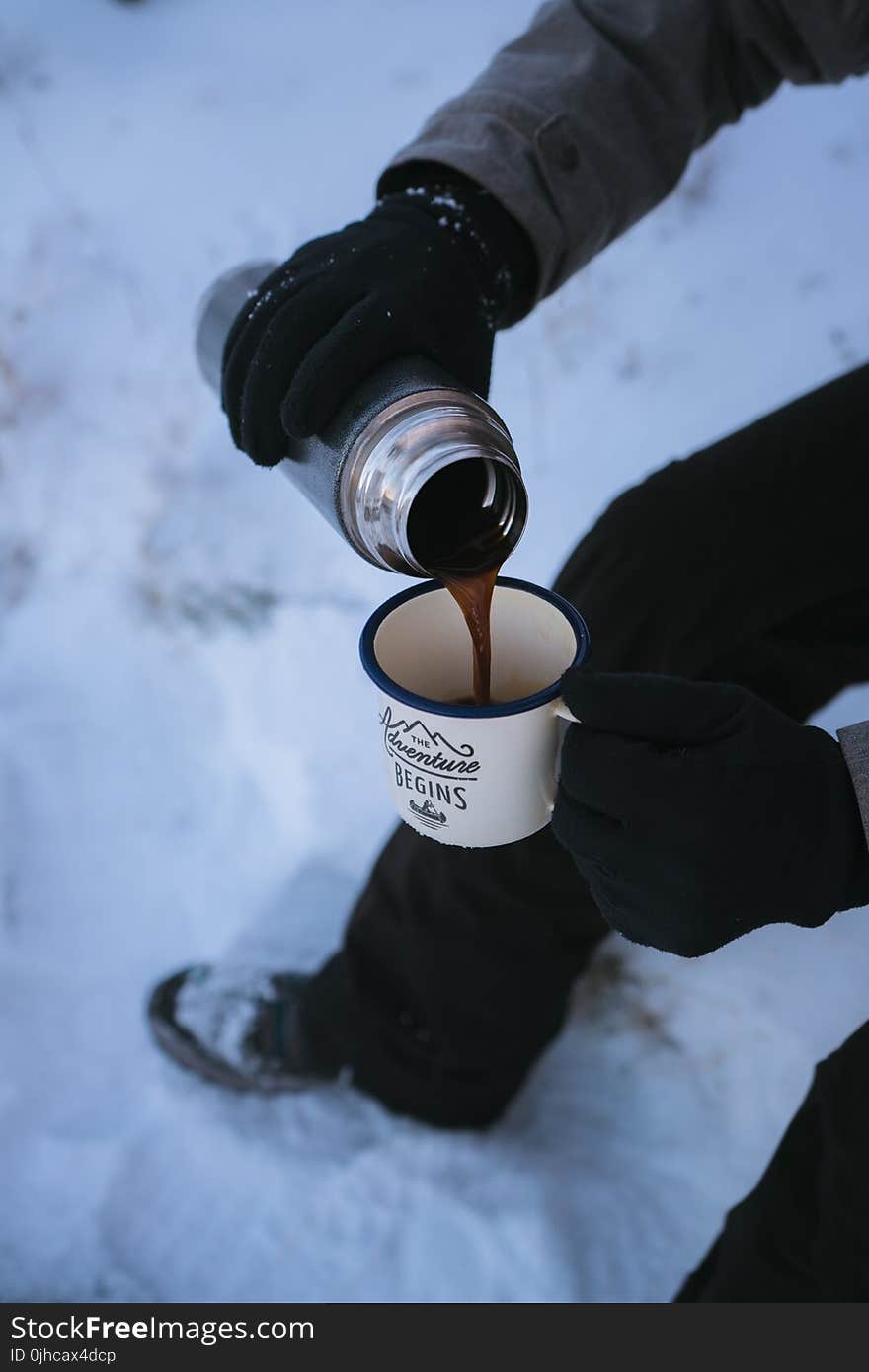 Photo of a Person Pouring Coffee in the Mug