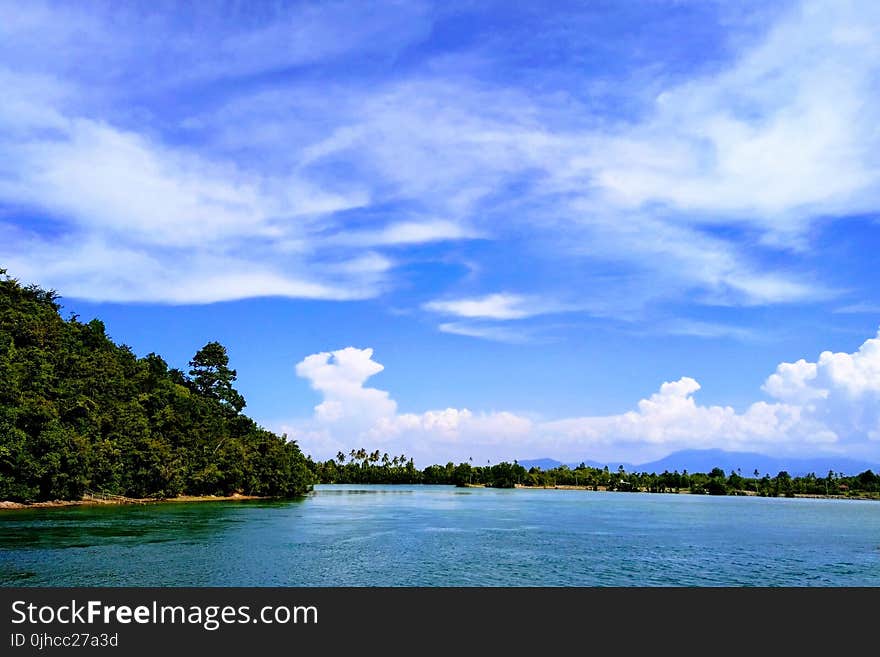 Ocean Under Blue Sky and White Clouds