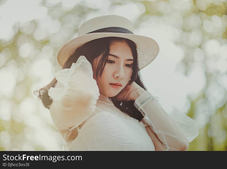 Woman Wears White Dress and Brown Hat