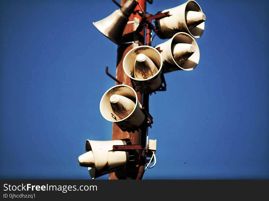 Megaphone Speakers on Wooden Post