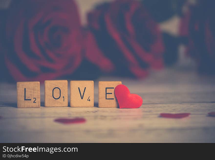 Close-up Photo of Wooden Scrabble Tiles Near Heart