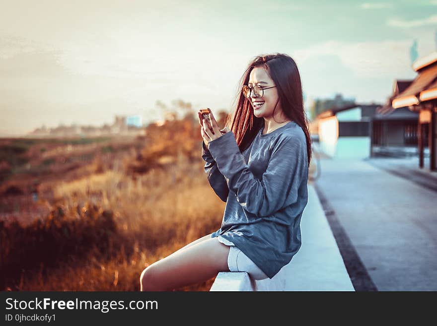 Woman Sitting Using Phone