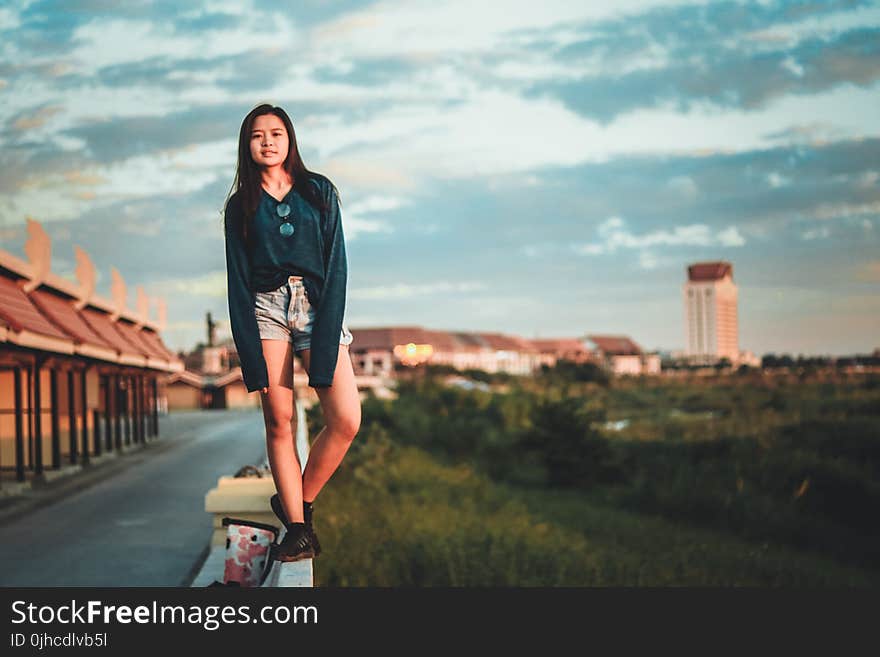 Woman Standing On Edge Of Wall