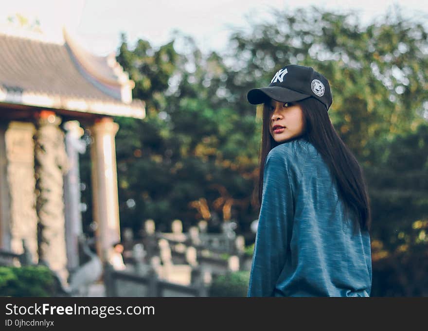 Woman Wearing Sweater And Baseball Cap