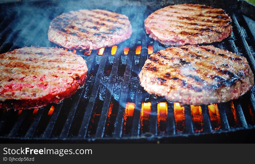 Shallow Focus Photo of Patties on Grill