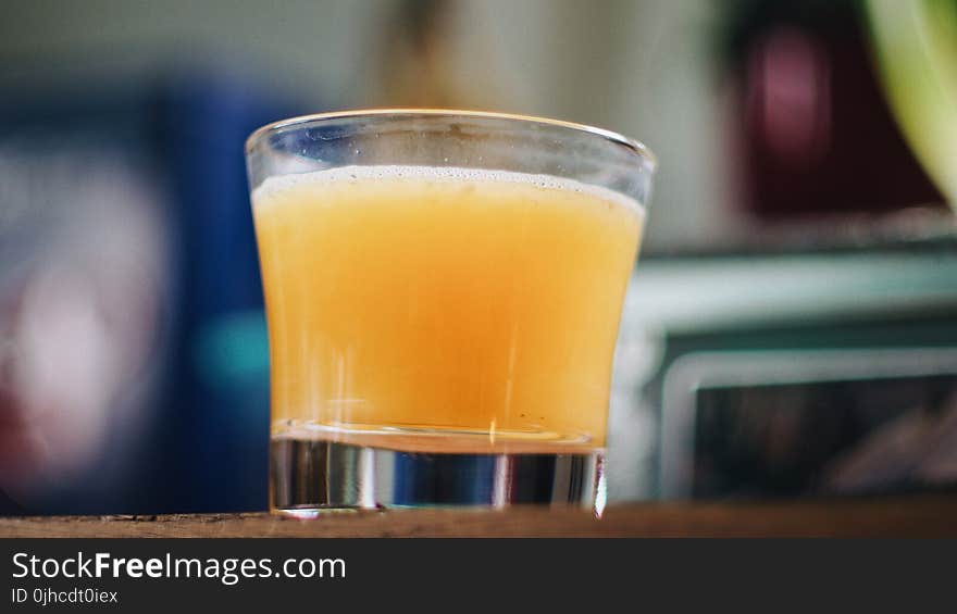 Clear Cut Shot Glass on Brown Wooden Talbe