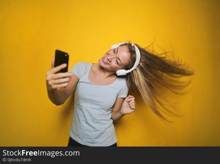 Photography of a Woman Listening to Music