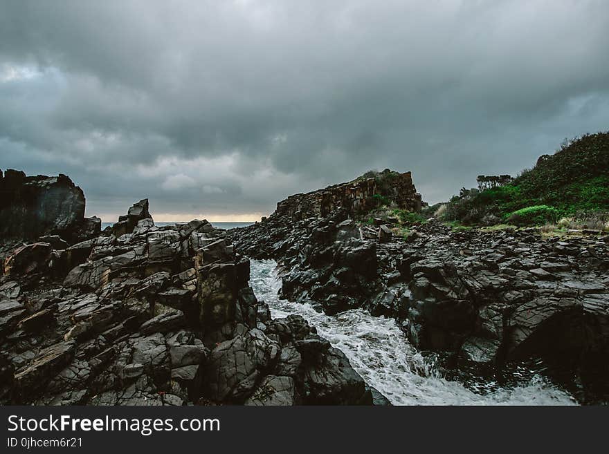 Rocky River Under Cloudy Sky