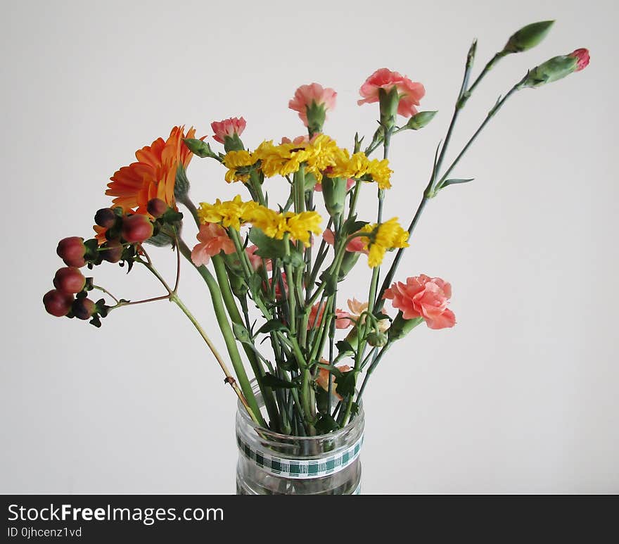 Clear Glass Vase With Red and Yellow Flowers