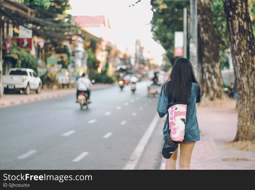 Photo of Woman Walking in the Street